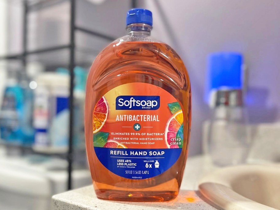 orange refill bottle of softsoap hand soap on bathroom counter