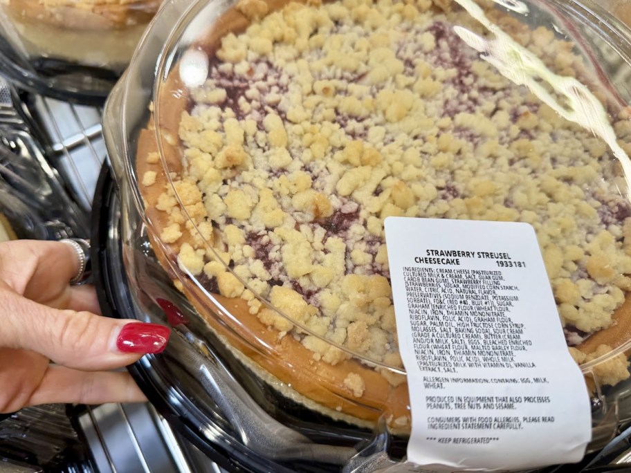 hand grabbing Strawberry Streusel Cheesecake