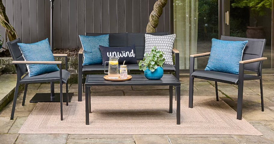 Black patio conversation set outside on outdoor rug