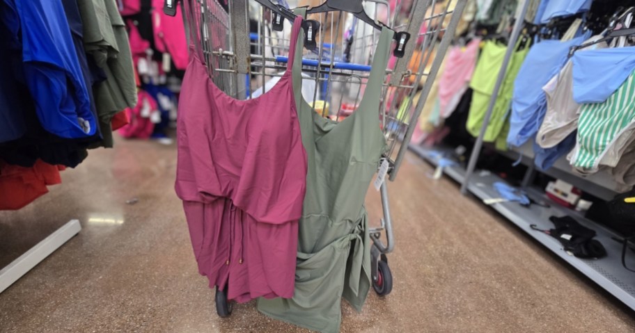 time and tru women's swim rompers and swimsuits hanging in walmart shopping cart.