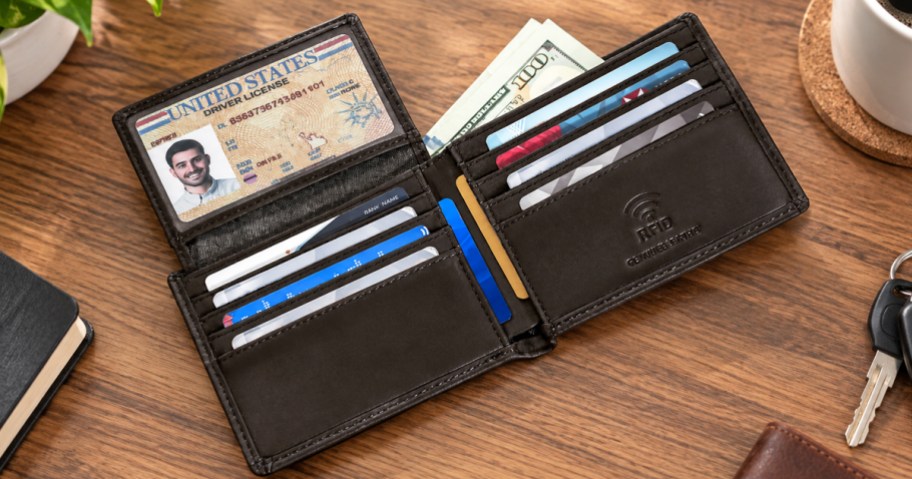 opened leather wallet on a wood desk