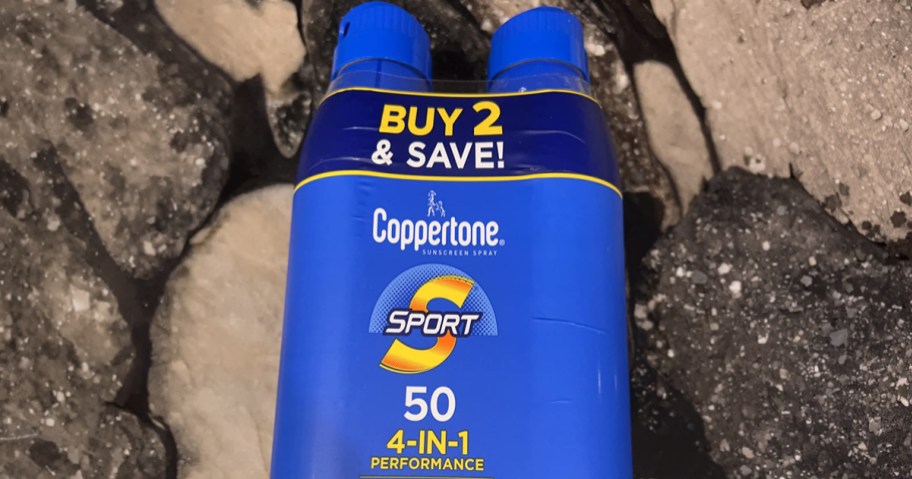 Two Cans of Coppertone Sport 50SPF Sunscreen on a counter