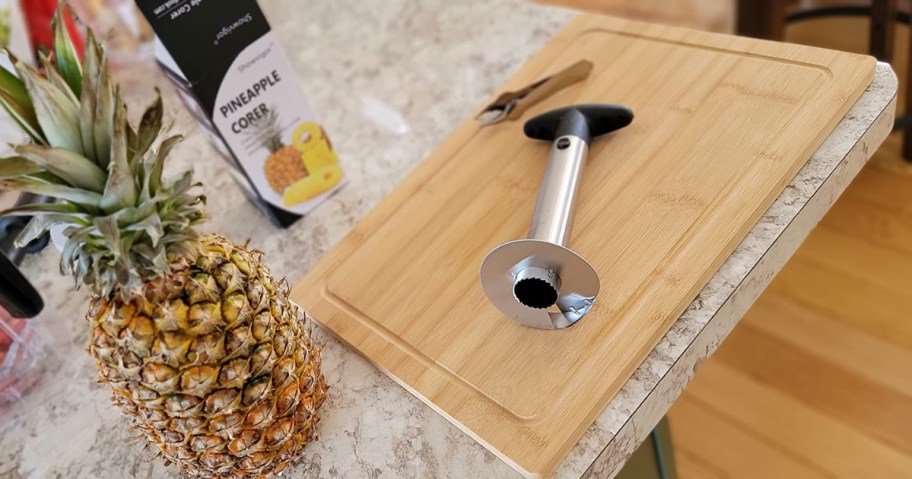 UMUACCAN pineapple corer and pineapple on kitchen counter with cutting board