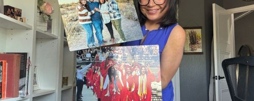 Woman holding two metal photo prints from Walgreens fearuring a family of four and teens at a graduation wearing red caps and gowns
