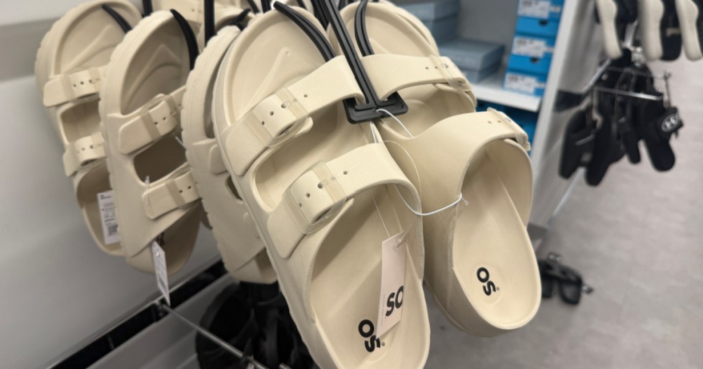 White women's slide sandals hanging on display inside Kohl's store