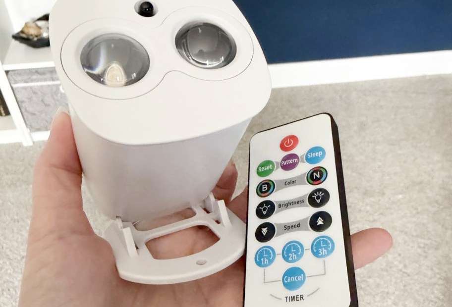 hand holding galaxy projector and remote 