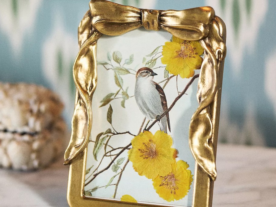gold bow picture frame with bird