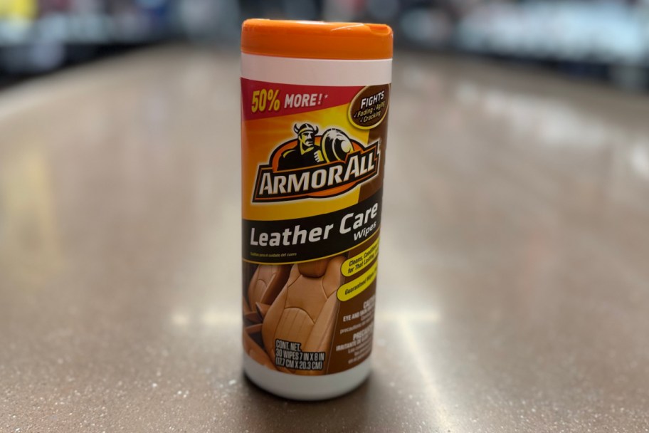 orange canister of car wipes on floor