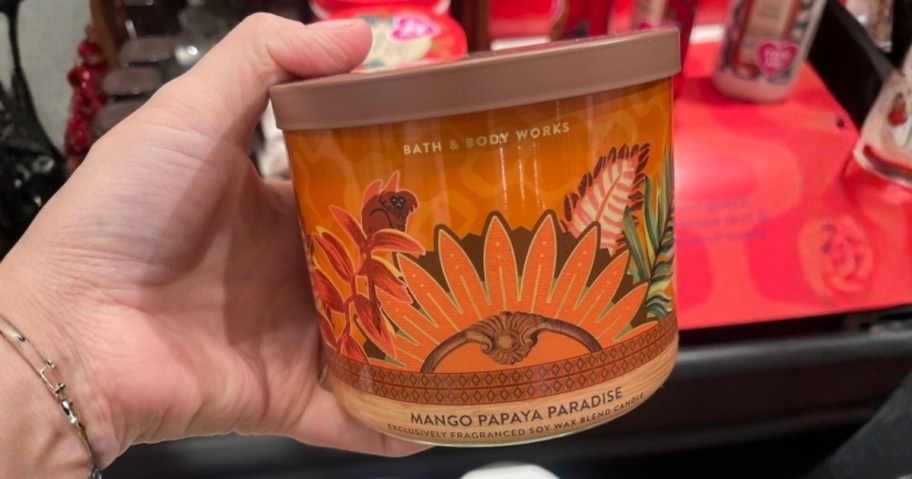 hand holding a Bath & Body Works 3-wick candle