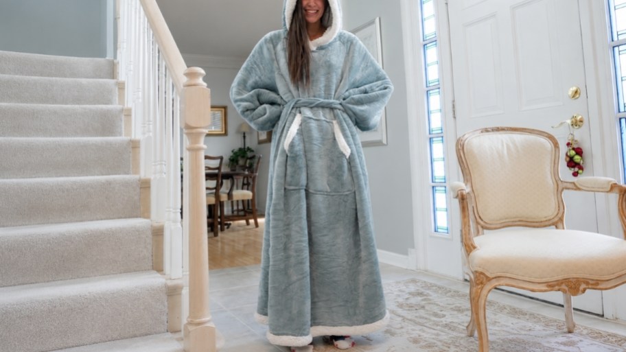 woman in a light green wearable blanket