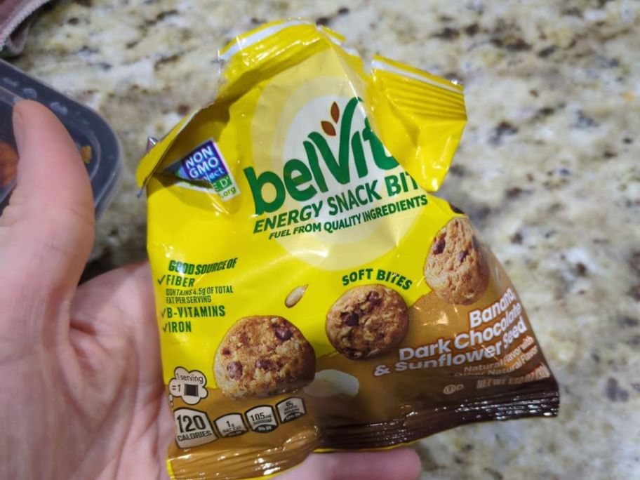 Hand holding a bag of BelVita Bites