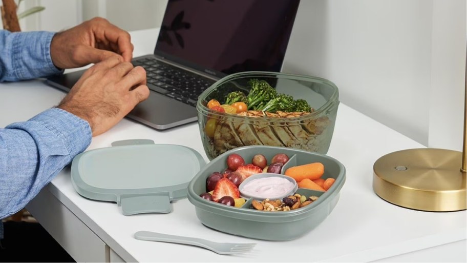 a green bentgo salad set on a desk