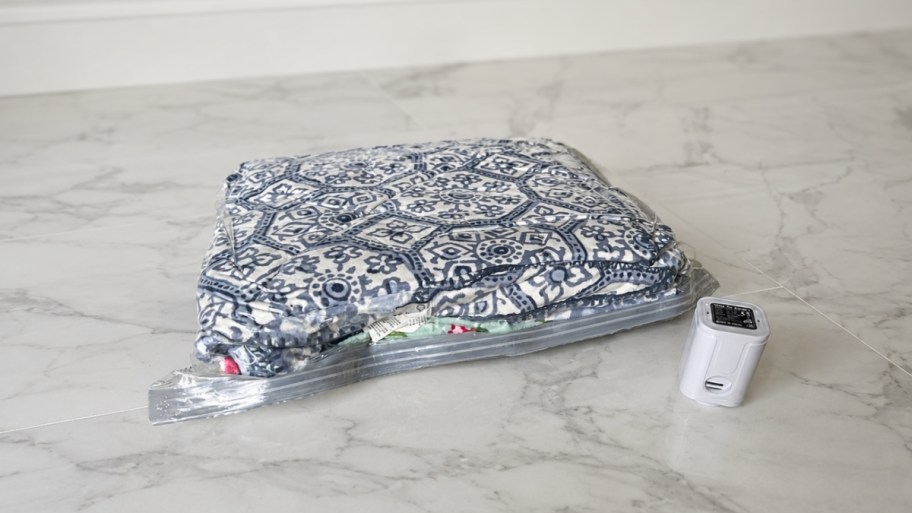 a vacuum bag with items in it next to an electric airpump