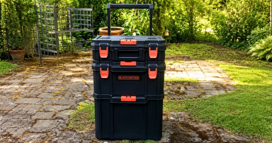 a Black+Decker 3-piece rolling stackable storage system in a backyard