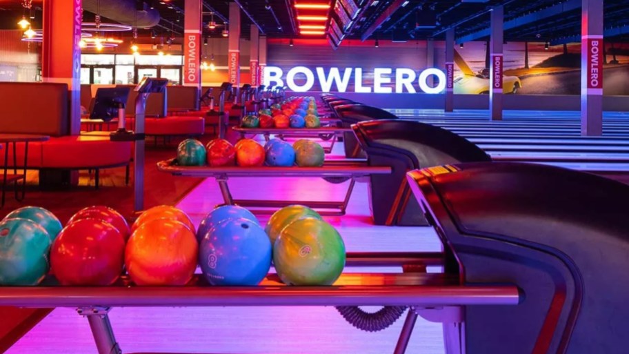 a row of bowling balls in a bowling alley