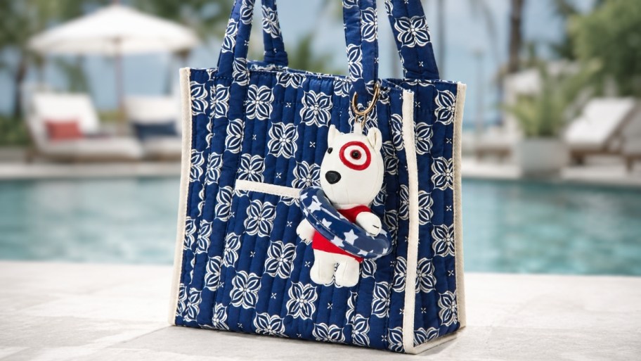 bullseye bag charm on a blue quilted tote bag. 
