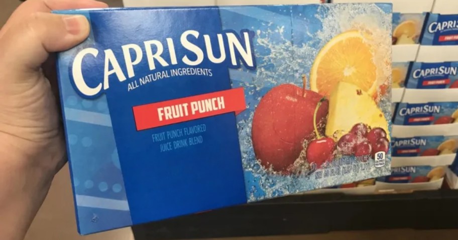 hand holding a box of Capri Sun Fruit Pouches