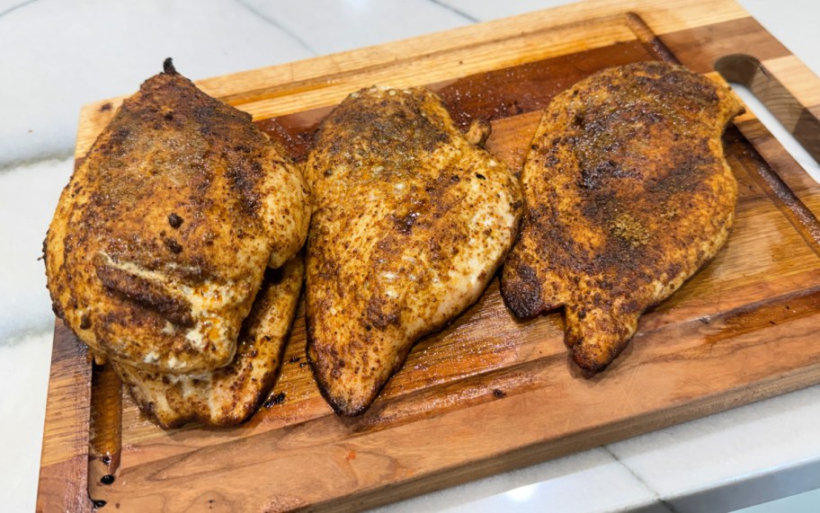chicken breasts on a cutting board 