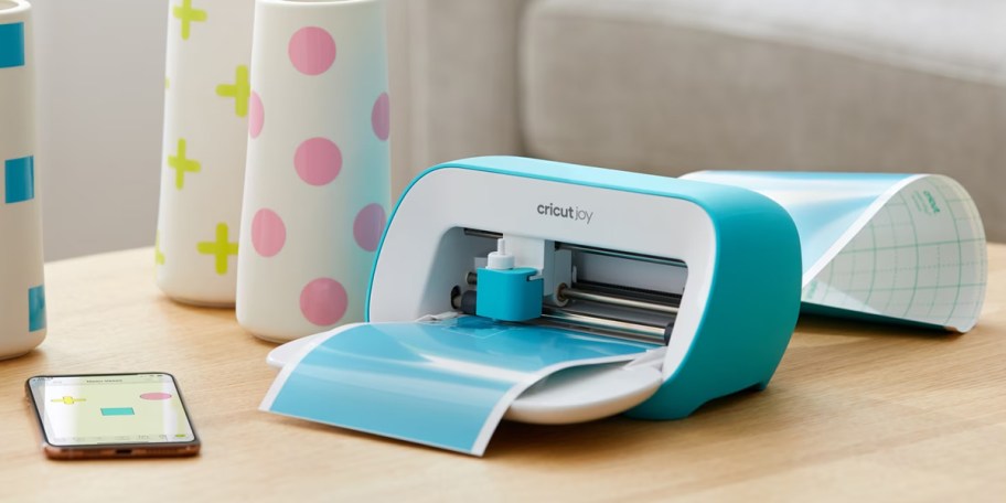 blue cricut joy with blue vinyl being cut 