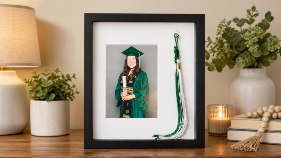 graduation tassel and photo frame on a table top