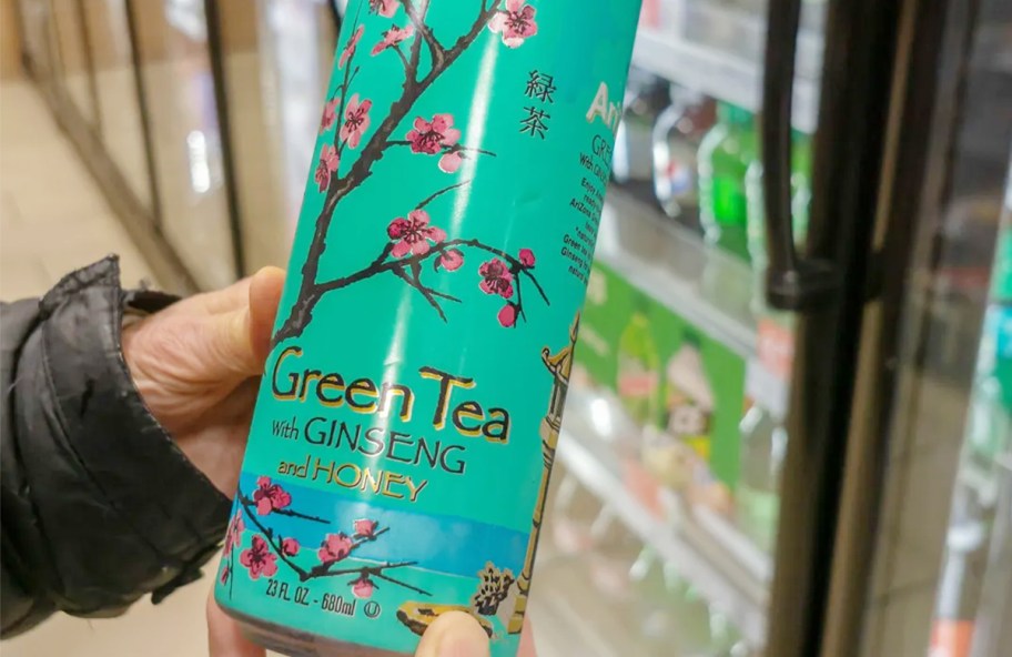 hand holding green tea can 