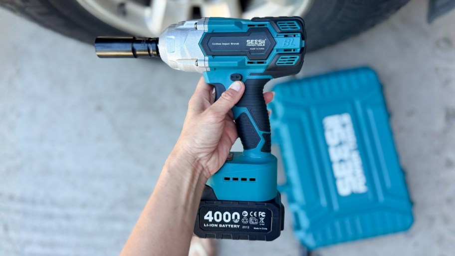 a hand holding an impact wrench