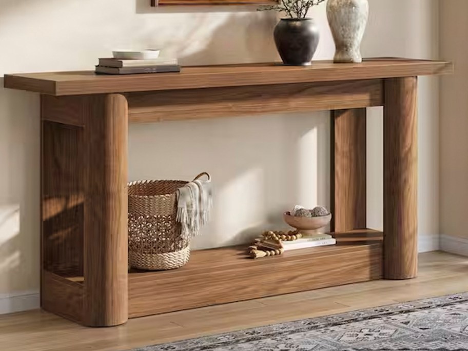 wood entryway table with decor 