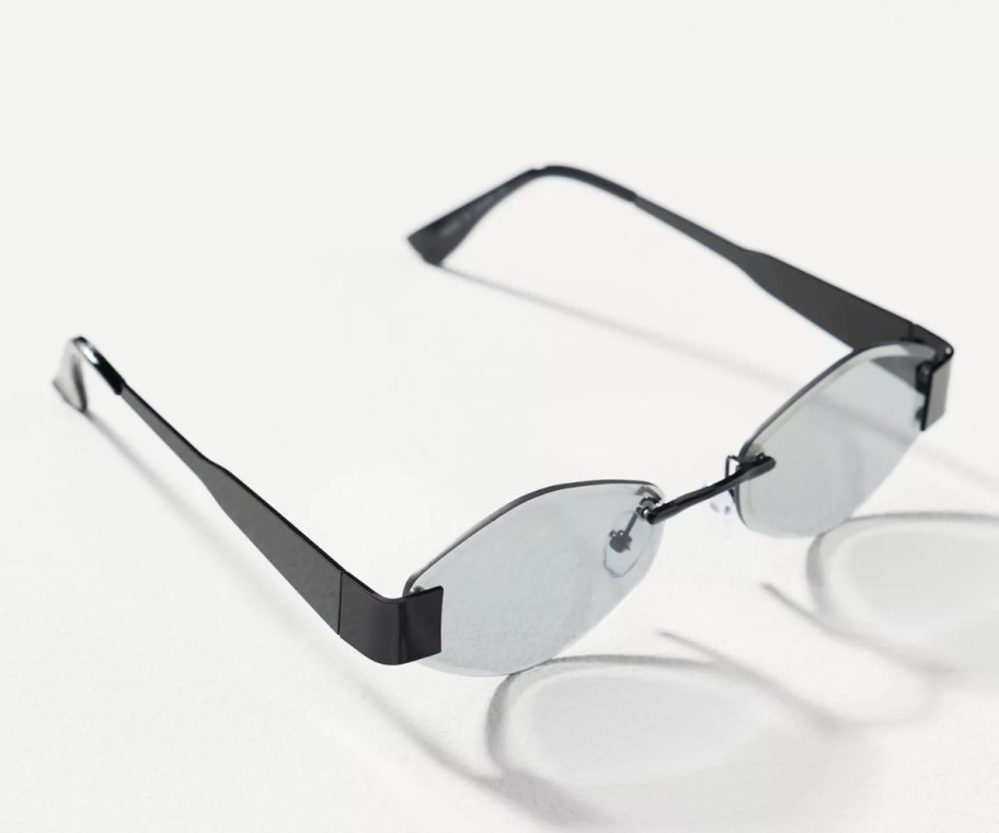 a pair of black rimless sunglasses