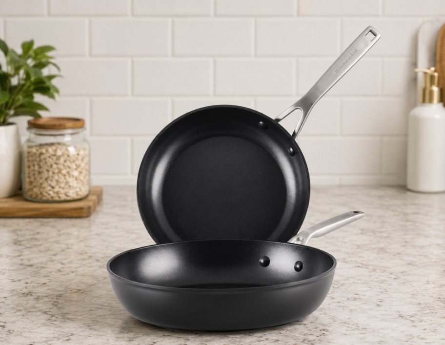 a set of black induction fry pans on a counter top