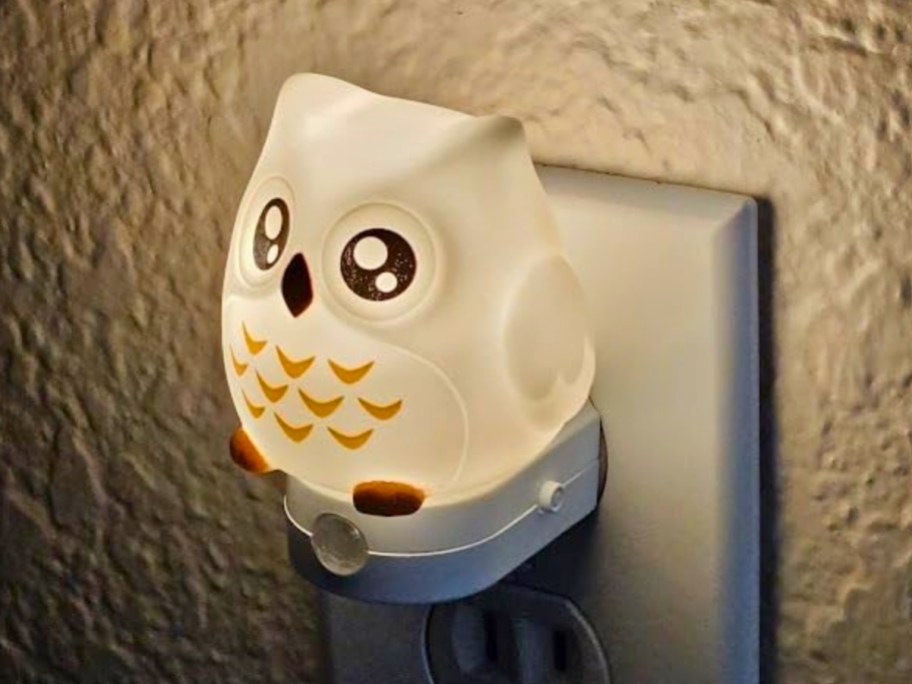an owl shaped nightlight plugged into an electrical outlet