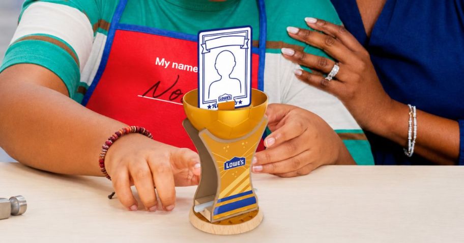 kid holding trophy cup at lowes store