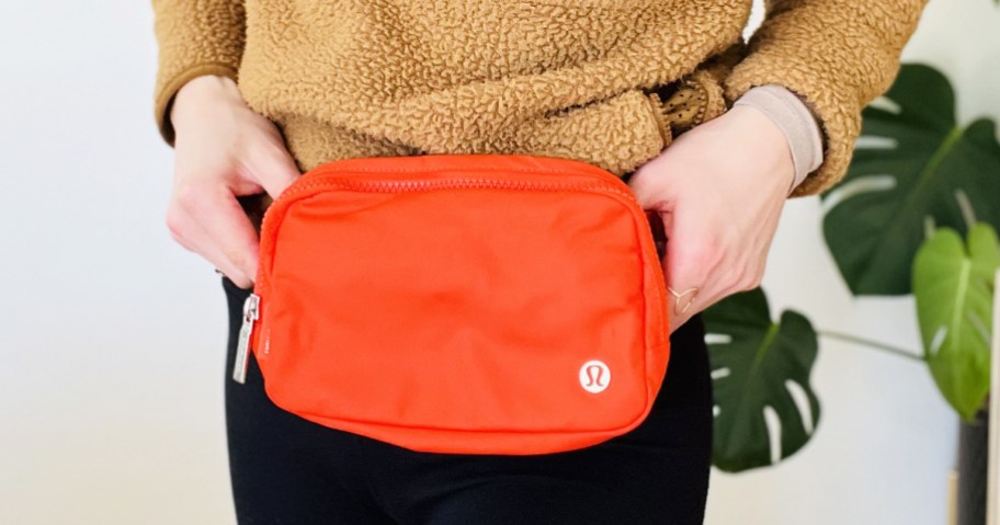 woman wearing a red lululemon belt bag