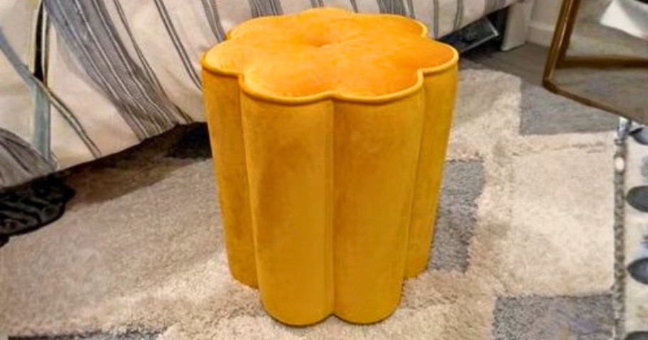 a yellow flower shaped ottoman in a bedroom