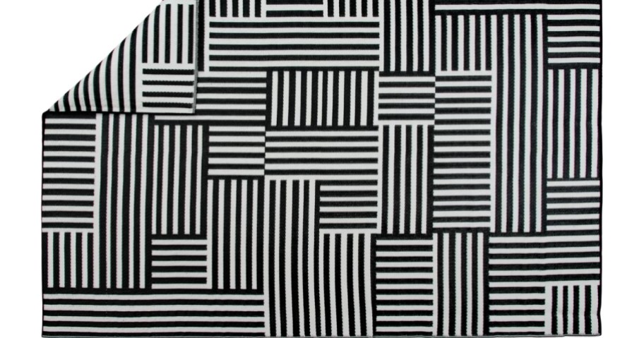a black and white striped outdoor rug