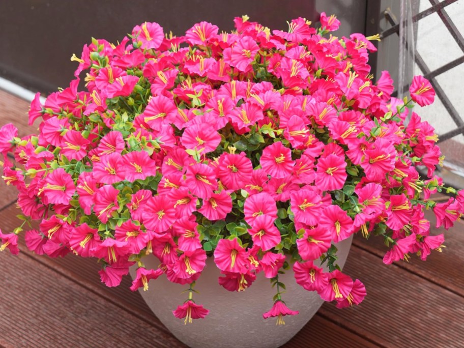 hot pink artificial flowers in a planter