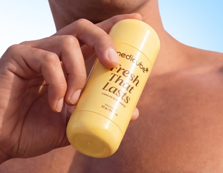man holding a deodorant stick