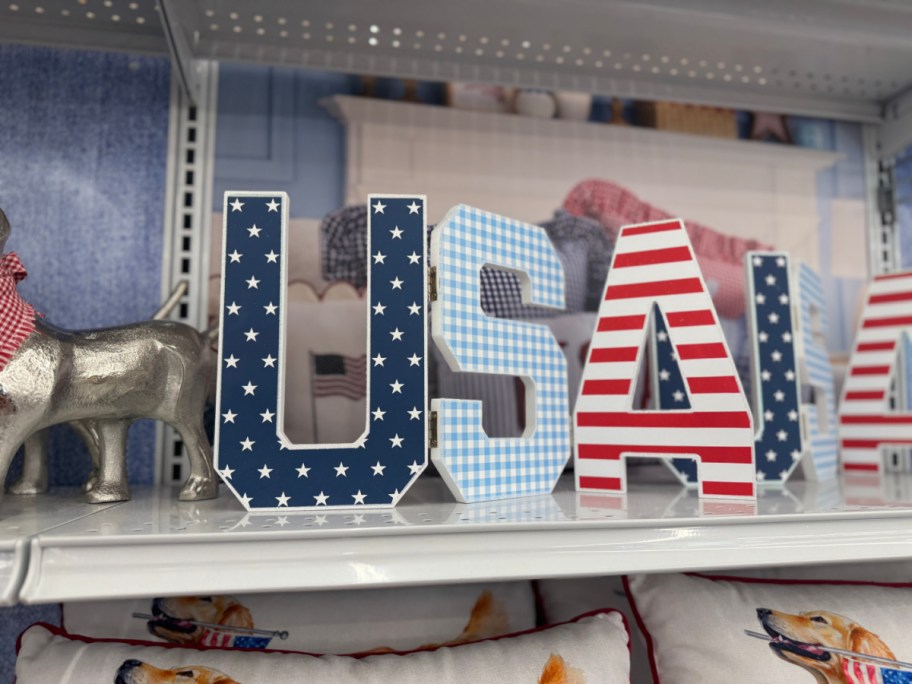 Patriotic "USA" signage with stars and stripes on a shelf.