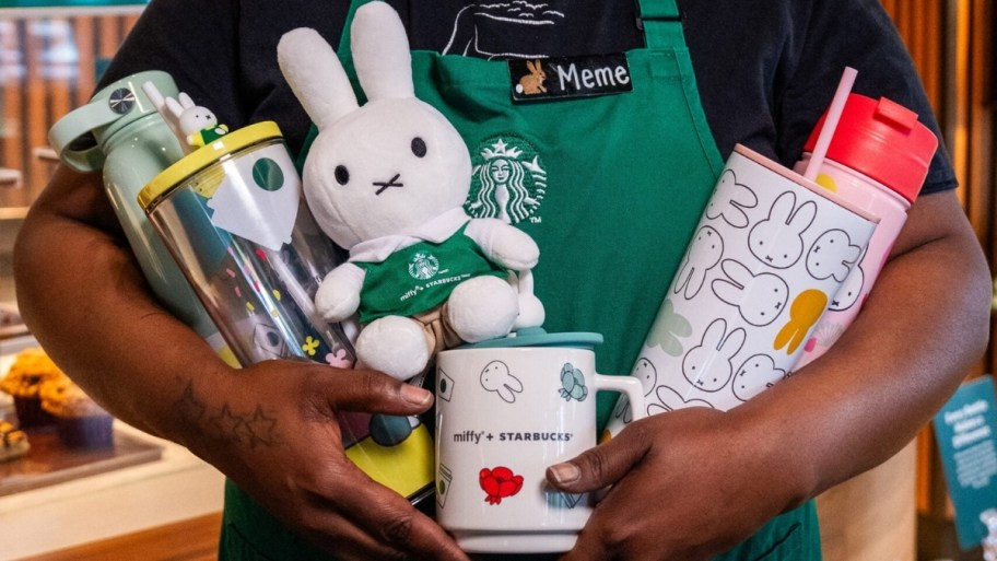 a woman holding items from the miffy x starbucks collab