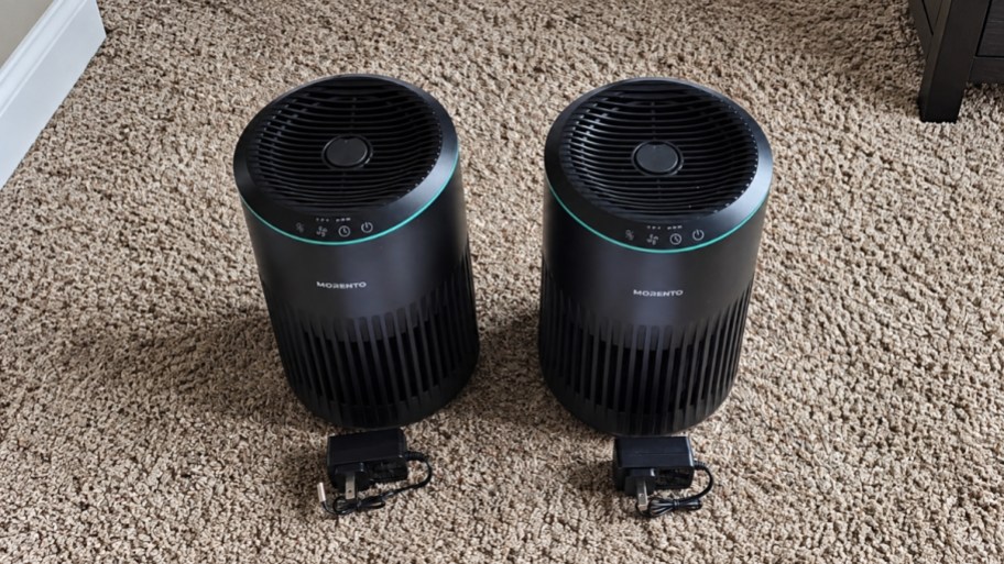 2 black air purifiers