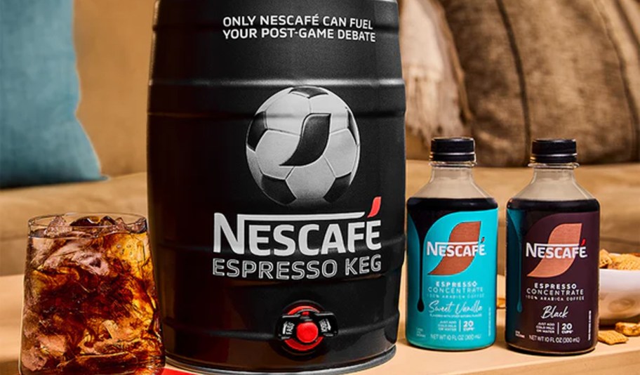 nescafe keg with bottles next to it