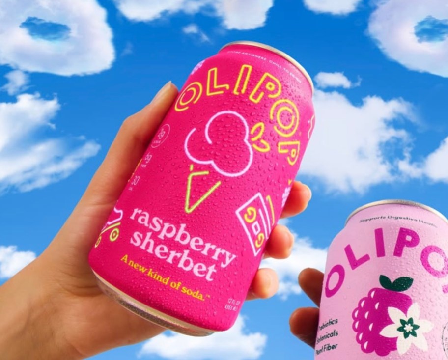 Hand holding a can of olipop raspberry sherbet