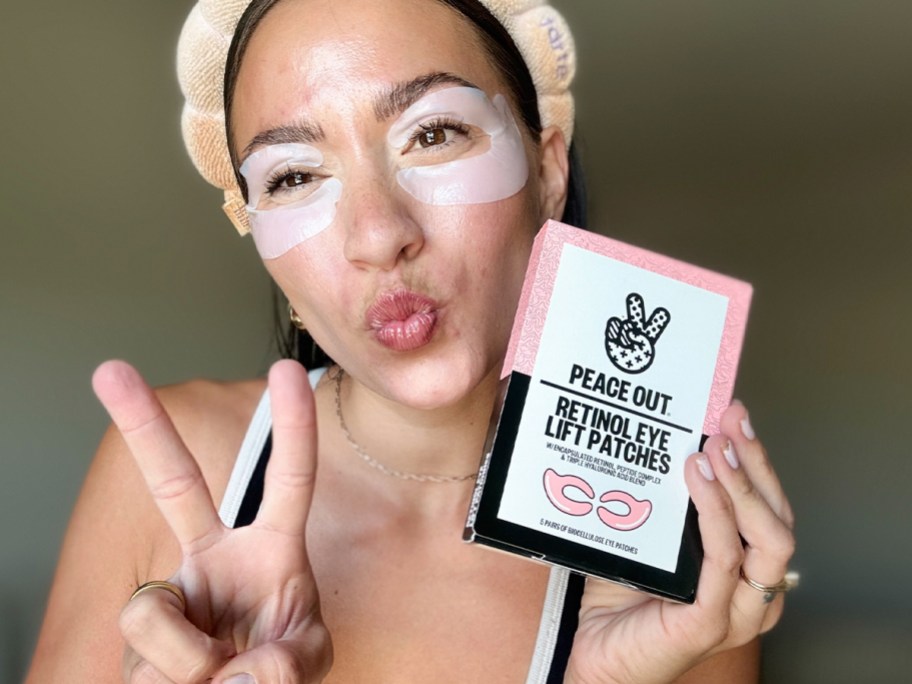 woman holding peace out retinol patches box with patches on face