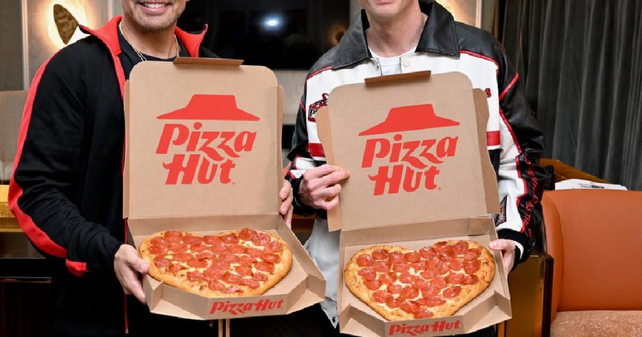 two men holding up pizza hut heart pizzas