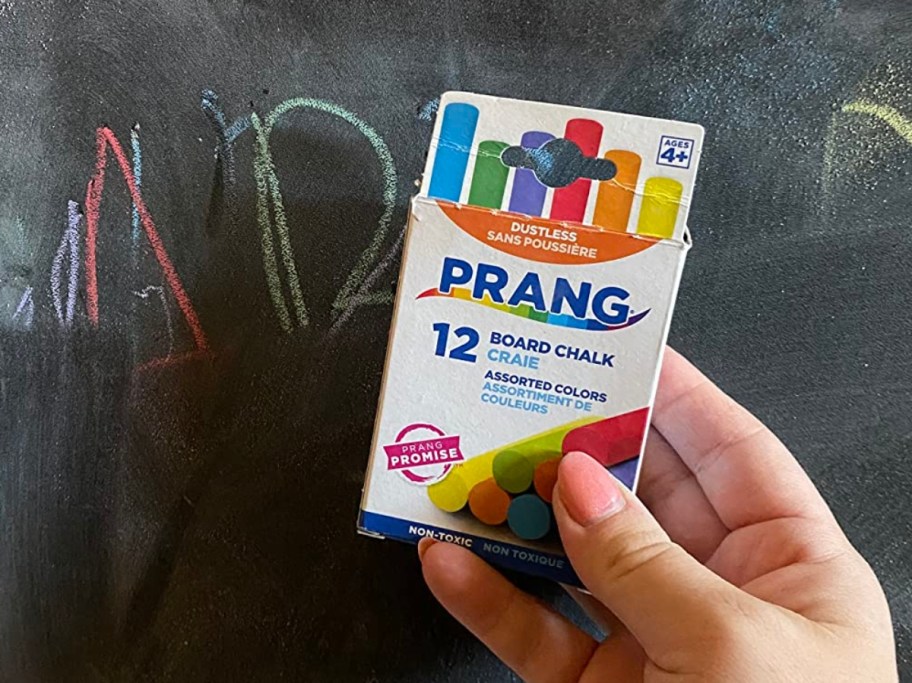 holding a box of colorful chalk