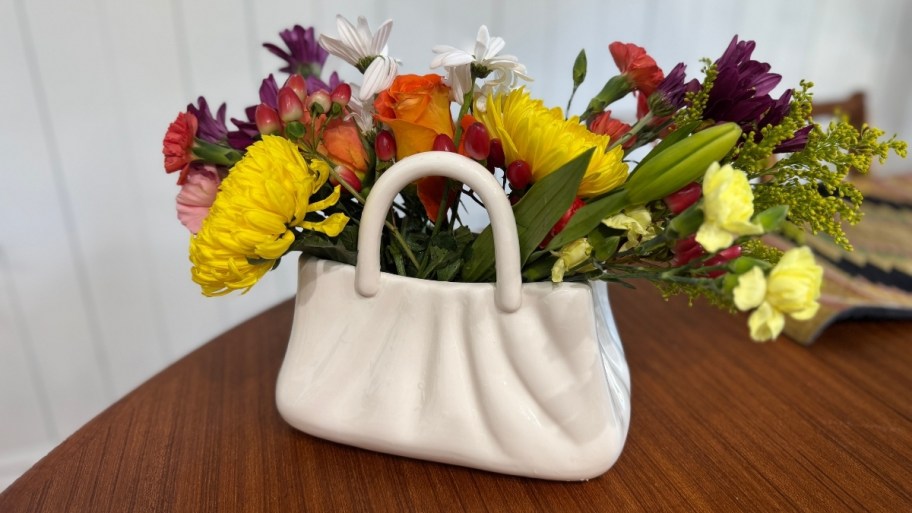 purse vase with floral arrangement