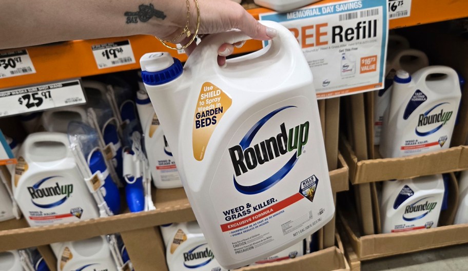 hand holding round up weed killer 
