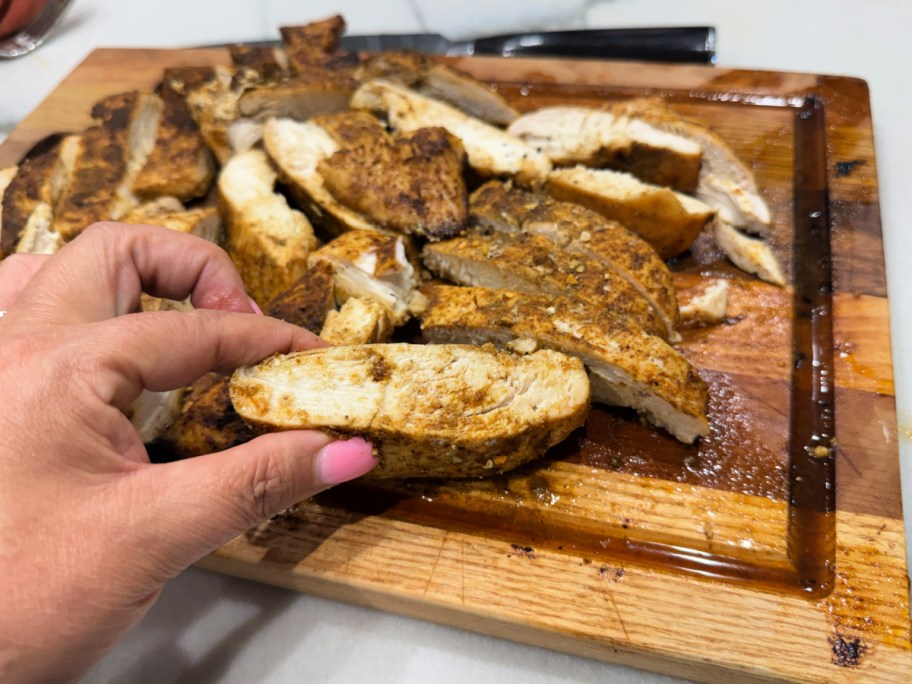 sliced baked chicken on a cutting board