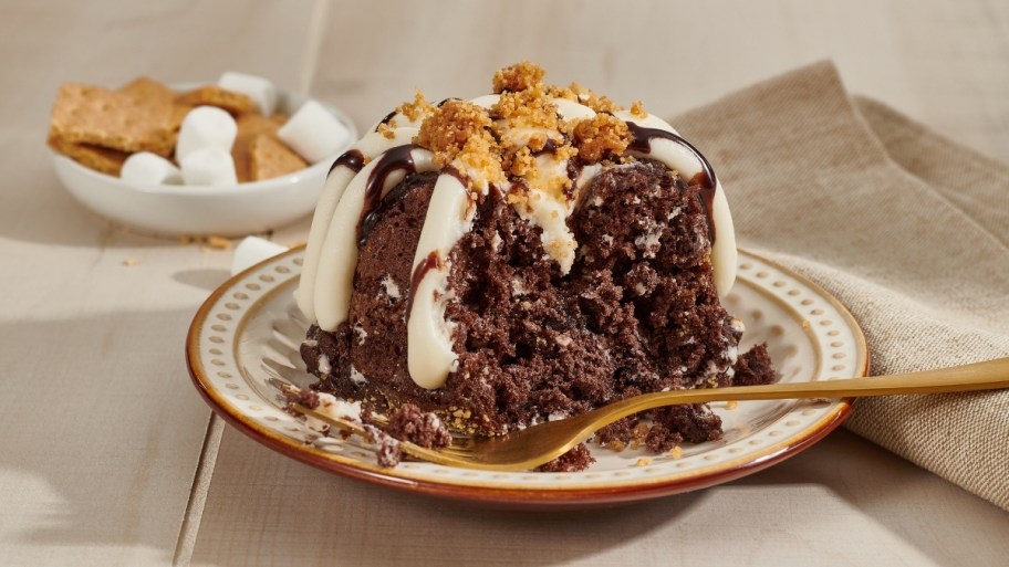 a smores flavored nothing bundt cakes bundtlet on a plate with a fork