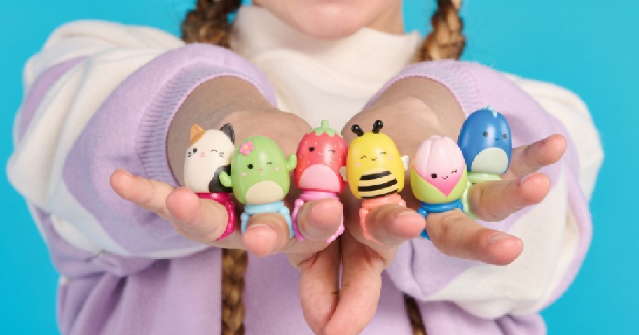 girl wearing squishalongs toys on her hands
