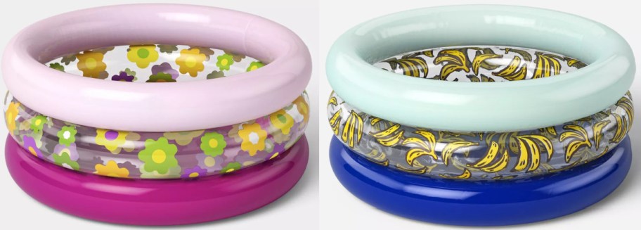 Two inflatable kiddie pools are side by side. The left pool has pink, yellow, and green floral patterns with pink rims. The right pool features yellow bananas on a white background with pale blue rims.